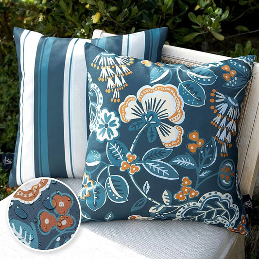 Coastal Bloom waterproof outdoor cushion cover set in Teal Spice, 45x45cm 2-pack with floral and striped designs in teal, white, and warm orange tones.