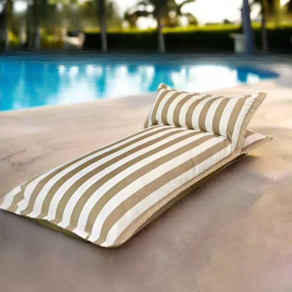 Product image of the Big Bertha single floating beanbag lounger cover in khaki and white stripe, displayed beside an outdoor pool.