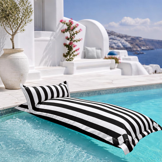 Black and white striped Big Bertha Premium Single floating beanbag lounger cover in a swimming pool, 70 x 180 cm