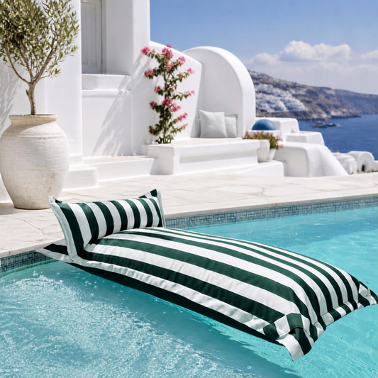 White and dark green striped Big Bertha Premium Single floating beanbag lounger cover in a swimming pool, 70 x 180 cm.