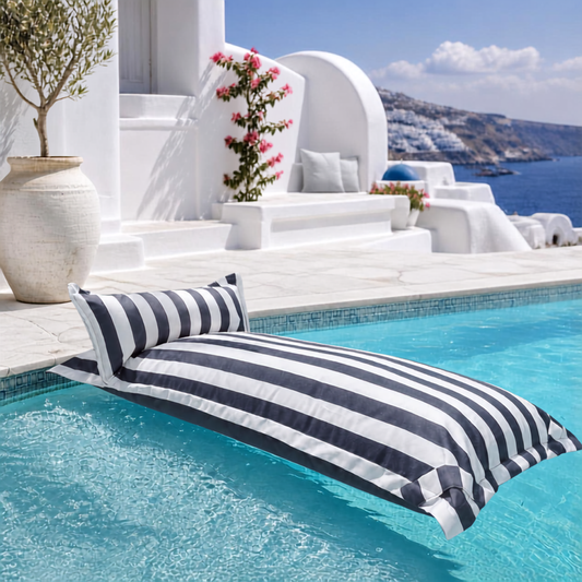 White and dark grey striped Big Bertha Premium Single floating beanbag lounger cover in a swimming pool, 70 x 180 cm.