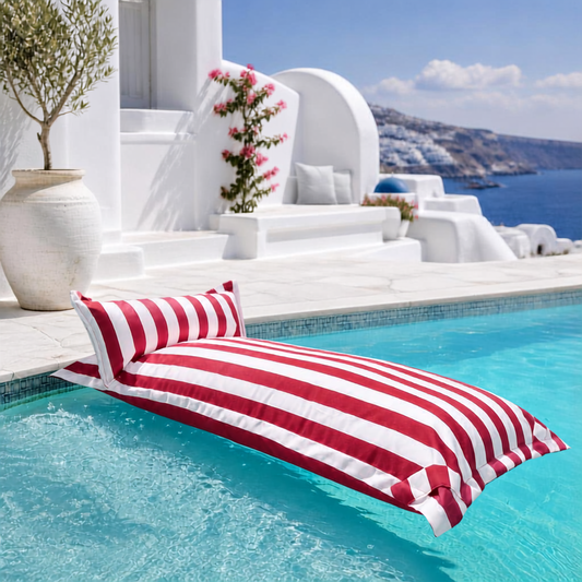 White and red striped Big Bertha Premium Single floating beanbag lounger cover in a swimming pool, 70 x 180 cm.