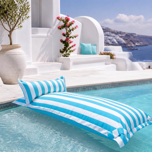 White and sky blue striped Big Bertha Premium Single floating beanbag lounger cover in a swimming pool, 70 x 180 cm.