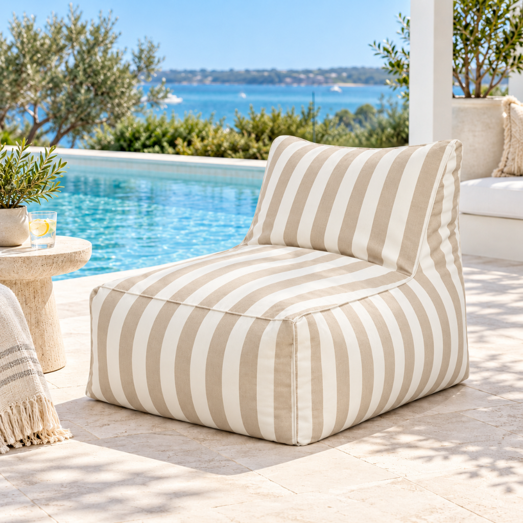 Khaki and white striped Hamptons outdoor bean bag lounge chair styled beside a swimming pool