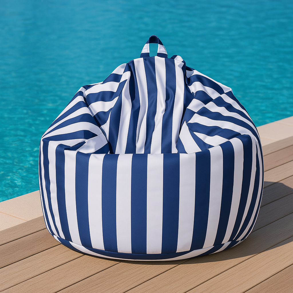 Dark blue and white striped outdoor bean bag chair on a light timber deck beside a turquoise swimming pool