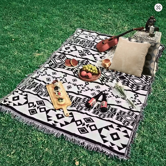 Lifestyle image of the Coastal Picnic Rug displayed in an outdoor setting.