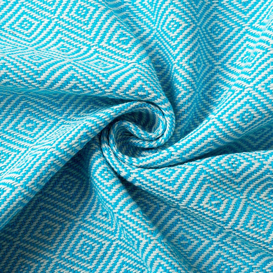 Close-up of blue Turkish towel fabric showing jacquard weave texture and cotton detail.