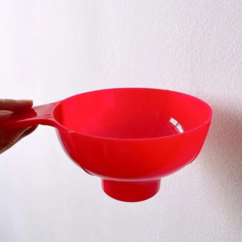Plastic funnel being used to pour beanbag filling beads