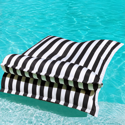 Black and white striped Big Bertha Premium Double floating beanbag lounger cover in a swimming pool, 140 x 180 cm.