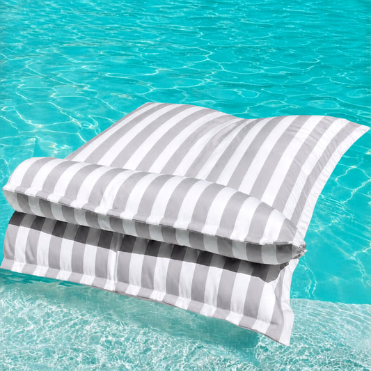 White and light grey striped Big Bertha Premium Double floating beanbag lounger cover in a swimming pool, 140 x 180 cm.