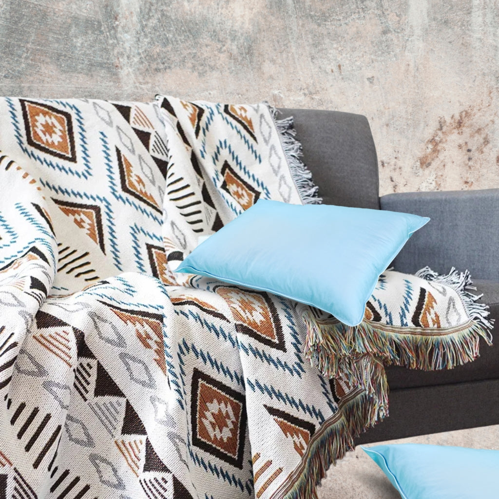 Close-up of the Coastal Picnic Rug showing the Desert Diamond jacquard pattern and tassel trim.