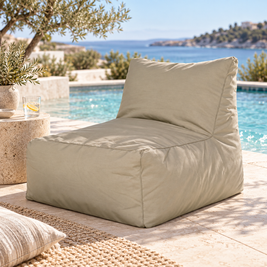 Dark sand Hamptons outdoor bean bag lounge chair styled in a coastal poolside setting