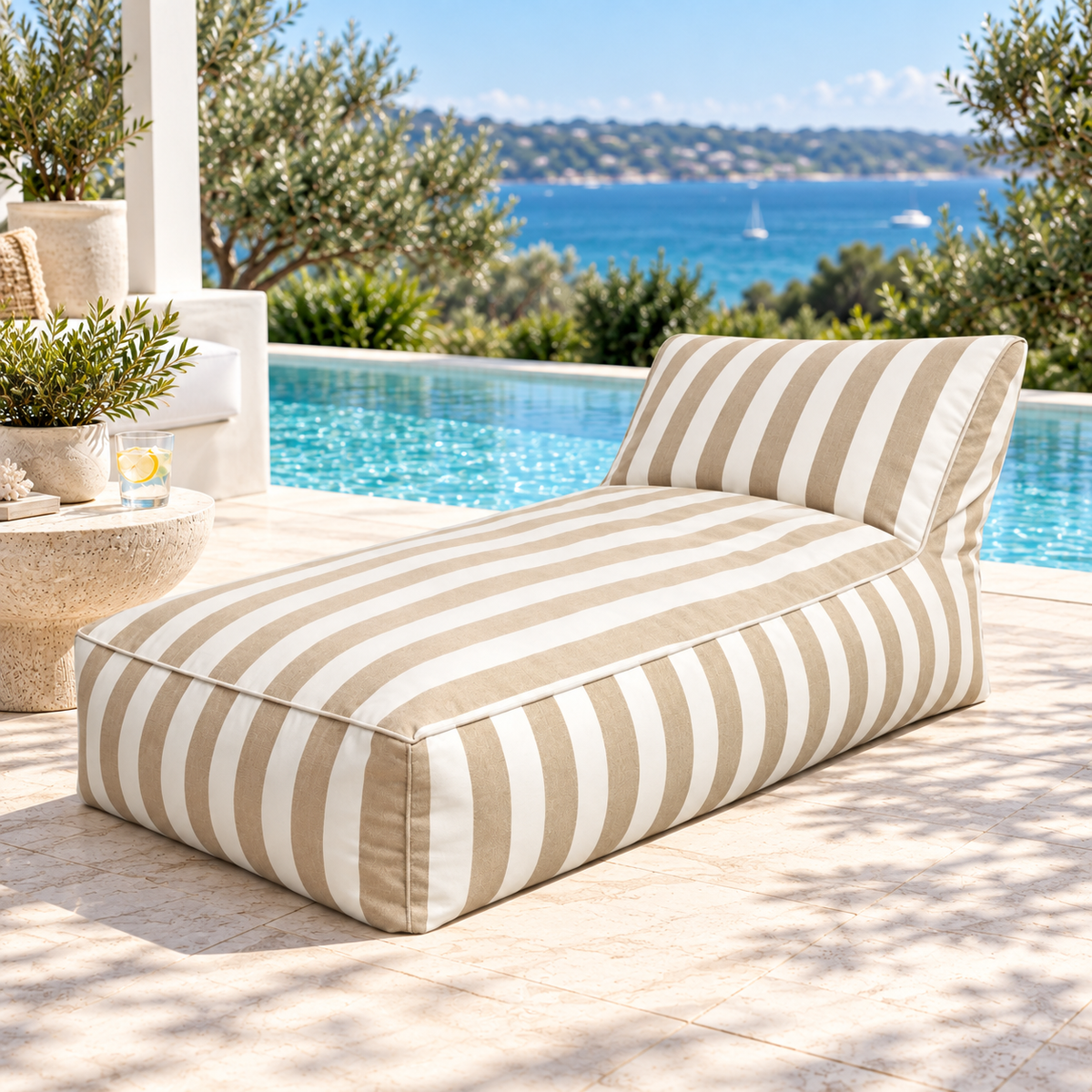 Khaki and white striped Hamptons outdoor chaise bean bag styled in a coastal poolside setting