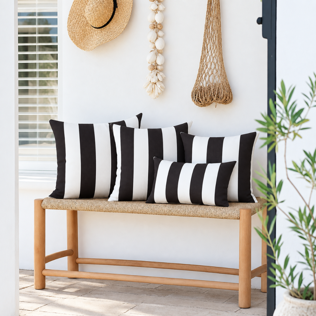 Hamptons black and white striped weatherproof outdoor cushion covers, with three 45 x 45 cm cushions and one 30 x 50 cm lumbar cushion styled on a timber bench.