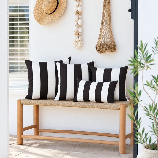 Hamptons black and white striped weatherproof outdoor cushion covers, with three 45 x 45 cm cushions and one 30 x 50 cm lumbar cushion styled on a timber bench.