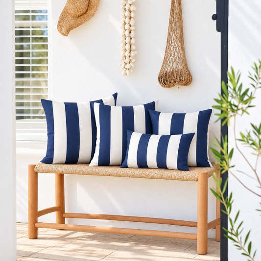 Hamptons navy and white striped weatherproof outdoor cushion covers, with three 45 x 45 cm cushions and one 30 x 50 cm lumbar cushion styled on a timber bench.