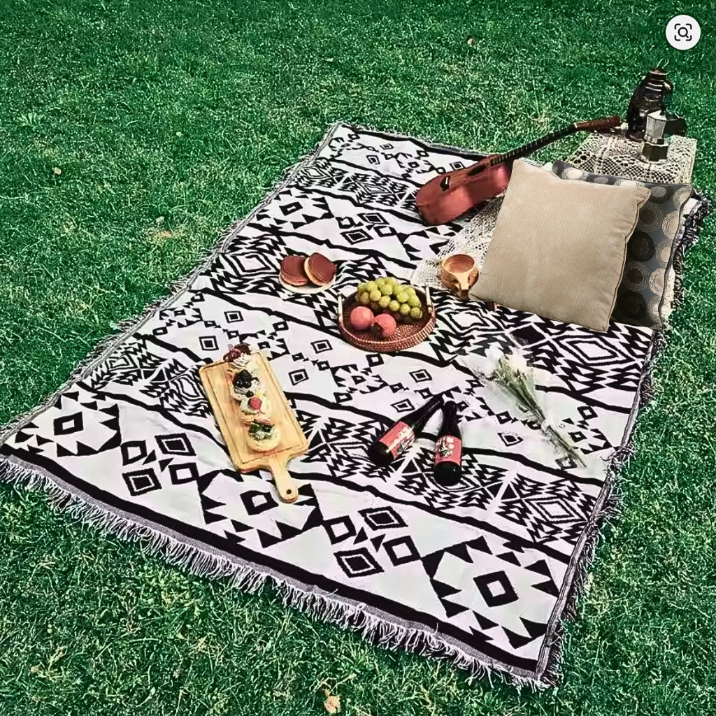 Lifestyle image of the Coastal Picnic Rug displayed in an outdoor setting.