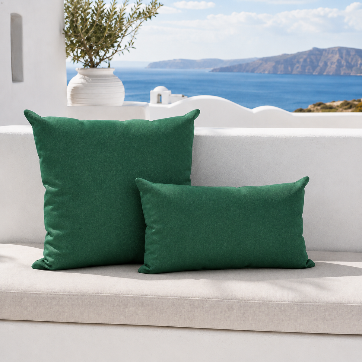 Santorini dark green weatherproof outdoor square and lumbar cushions styled in a bright white Mediterranean outdoor setting
