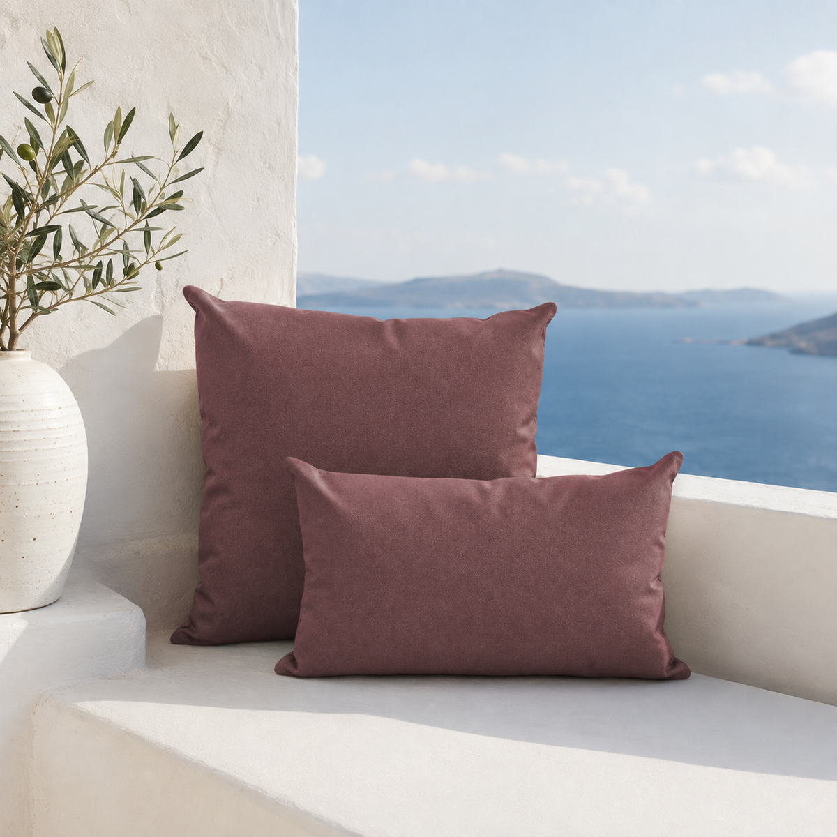 Santorini coffee weatherproof outdoor square and lumbar cushions styled on a white Santorini bench with sea view