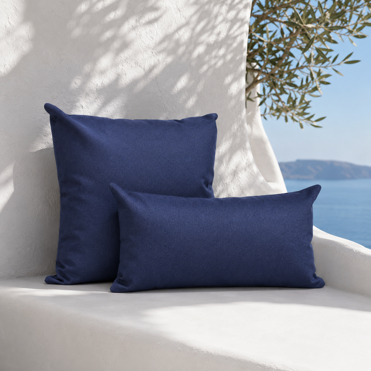 Santorini navy weatherproof outdoor square and lumbar cushions styled in a white Mediterranean seating nook